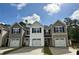 New townhomes displaying varied siding, black shutters, one-car garages, and concrete driveways at 265 Christiana Ln. # A, Myrtle Beach, SC 29579