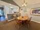 Dining area open to kitchen and living room with a wooden table, bar stools, and inviting decor at 270 Pinehurst Dr. # 9-I, Pawleys Island, SC 29585