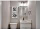 Half bath features a vanity with marble countertop and coastal decor at 301 43Rd Ave. N, North Myrtle Beach, SC 29582