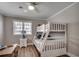 Bedroom featuring bunkbeds with beige stripes, a table, and white decor at 301 43Rd Ave. N, North Myrtle Beach, SC 29582