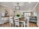 Open dining area with modern light fixture flows into a cozy living space at 301 43Rd Ave. N, North Myrtle Beach, SC 29582
