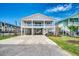 Charming beach home with covered parking and well-manicured landscaping for a cozy curb appeal at 301 43Rd Ave. N, North Myrtle Beach, SC 29582