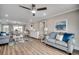 Bright living room with hardwood floors, neutral walls, and beach-themed decor at 301 43Rd Ave. N, North Myrtle Beach, SC 29582