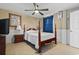 Bedroom with wooden post bed, ceiling fan, and TV at 306 59Th Ave. N, North Myrtle Beach, SC 29582