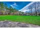 Expansive grassy backyard with a glimpse of the house and trees at 3173 Long Avenue Ext., Conway, SC 29526