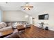 Living room with hardwood floors, L-shaped sofa and large TV at 352 Beulah Circle, Conway, SC 29527