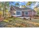 Brick home with a patio and trees at 385 Muirfield Dr., Pawleys Island, SC 29585