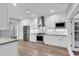 Modern kitchen with stainless steel appliances, white cabinets, and tile backsplash at 385 Muirfield Dr., Pawleys Island, SC 29585