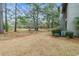 Lawn area with mature trees and landscaping, with a view of the building's exterior at 401 Indian Wells Ct. # 401, Murrells Inlet, SC 29576