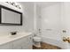 Well-lit bathroom features a framed mirror, white vanity, and combined tub and shower at 401 Indian Wells Ct. # 401, Murrells Inlet, SC 29576