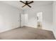 A bright bedroom with neutral carpet features a ceiling fan, and closet and bathroom access at 401 Indian Wells Ct. # 401, Murrells Inlet, SC 29576