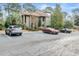 Exterior view of the building with parking, surrounding mature trees, and tidy landscaping at 401 Indian Wells Ct. # 401, Murrells Inlet, SC 29576