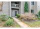 Exterior shot of the building with landscaping, front door and view of upper and lower floors at 401 Indian Wells Ct. # 401, Murrells Inlet, SC 29576