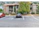 View of the building's exterior with parking, landscaping, and a well-maintained facade and car parked in parking space at 401 Indian Wells Ct. # 401, Murrells Inlet, SC 29576