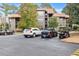 Exterior of the property showing parking spaces for residents and a golf cart and lush surrounding trees at 401 Indian Wells Ct. # 401, Murrells Inlet, SC 29576