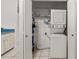 Convenient laundry room with a washer and dryer setup and storage shelves at 401 Indian Wells Ct. # 401, Murrells Inlet, SC 29576
