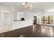 Open living room with hardwood floors, bright natural light, and a classic chandelier at 401 Indian Wells Ct. # 401, Murrells Inlet, SC 29576