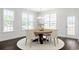 Bright dining area featuring a modern chandelier, wood floors, and view to the backyard at 4040 Bucolic Loop, Myrtle Beach, SC 29588