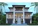 Stunning exterior view of a luxurious three-story home with balconies, complemented by lush tropical landscaping at 4702 N Ocean Blvd., Myrtle Beach, SC 29577