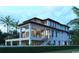 Angle view of a modern, multi-story home featuring multiple balconies, surrounded by a neatly manicured lawn at 4702 N Ocean Blvd., Myrtle Beach, SC 29577