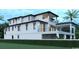 A multi-level home boasts a modern design, featuring an expansive porch and balconies perfect for enjoying outdoor living at 4702 N Ocean Blvd., Myrtle Beach, SC 29577