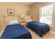 Twin bedroom with two beds, nightstand, and window at 4809 Luster Leaf Circle # 102, Myrtle Beach, SC 29577