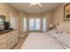 King bedroom with large window, dresser, and access to a full bathroom at 4809 Luster Leaf Circle # 102, Myrtle Beach, SC 29577
