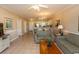 Open living room with tile floors, sofa, and views into the kitchen and dining area at 4809 Luster Leaf Circle # 102, Myrtle Beach, SC 29577