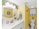 Small bathroom with white vanity, oval mirror, and yellow walls at 6001-Z34 S Kings Hwy., Myrtle Beach, SC 29575