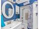 Bathroom with white vanity, blue walls, and nautical-themed shower curtain at 6001-Z34 S Kings Hwy., Myrtle Beach, SC 29575