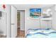 Small bedroom with a TV, fan, and twin bed with a nautical-themed comforter at 6001-Z34 S Kings Hwy., Myrtle Beach, SC 29575