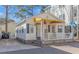 Charming cottage with yellow awning, white siding, and stone accents at 6001-Z34 S Kings Hwy., Myrtle Beach, SC 29575