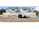 Townhouse exterior with parking and white fence at 618 3Rd Ave. S # 4B, North Myrtle Beach, SC 29582