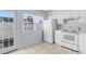 Kitchen with white cabinets, appliances, and access to a patio at 618 3Rd Ave. S # 4B, North Myrtle Beach, SC 29582