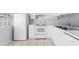 White kitchen with full-size appliances and tile floor at 618 3Rd Ave. S # 4B, North Myrtle Beach, SC 29582