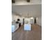 Modern kitchen with white cabinets, large island and hardwood floors at 640 Carter Reid Ct., Conway, SC 29526