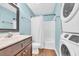 Bathroom featuring modern washer/dryer, wooden floors, a vanity, and a shower-tub combo at 661 Tupelo Ln. # 16B, Longs, SC 29568