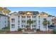 Charming condo complex featuring multiple balconies, lush landscaping, and well-maintained exterior at 661 Tupelo Ln. # 16B, Longs, SC 29568