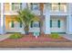 Close-up of the condo exterior with a building number sign amid the mature palm tree at 661 Tupelo Ln. # 16B, Longs, SC 29568