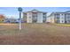Well-maintained apartment complex with manicured lawn and reserved parking spaces for residents at 661 Tupelo Ln. # 16B, Longs, SC 29568