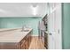 Bright, galley-style kitchen with stainless steel appliances and stylish countertops and wooden floors at 661 Tupelo Ln. # 16B, Longs, SC 29568