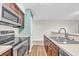 Well-lit kitchen featuring stainless steel appliances, wood cabinets, and modern countertops at 661 Tupelo Ln. # 16B, Longs, SC 29568