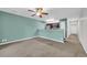 Bright, open-plan living room adjacent to kitchen, with neutral walls and ceiling fan at 661 Tupelo Ln. # 16B, Longs, SC 29568