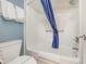 Simple white bathroom with shower/tub, toilet, and blue curtain at 6900 N Ocean Blvd. # 1439, Myrtle Beach, SC 29572