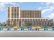 Beachfront view of building with beach chairs and umbrellas at 6900 N Ocean Blvd. # 1439, Myrtle Beach, SC 29572