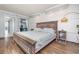 Spacious bedroom with a rustic wooden bed frame and light floors at 6900 N Ocean Blvd. # 1439, Myrtle Beach, SC 29572