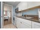 Small kitchen with granite countertops and white cabinets at 6900 N Ocean Blvd. # 1439, Myrtle Beach, SC 29572