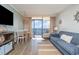Living room with ocean view, comfy couch, and TV at 6900 N Ocean Blvd. # 1439, Myrtle Beach, SC 29572