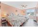 Bedroom with two beds, light walls, and a ceiling fan with wood-look flooring at 731 Yokley Ct., Surfside Beach, SC 29575