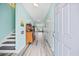 Light teal walls, wood-look floors, antique cabinet, and staircase at 731 Yokley Ct., Surfside Beach, SC 29575